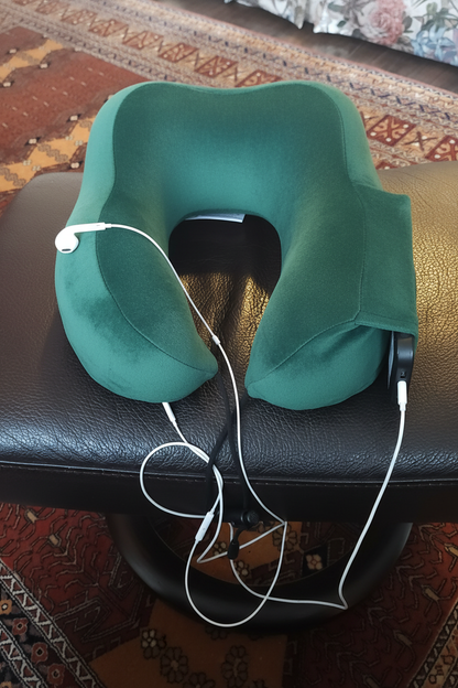 Green travel neck pillow with headphones